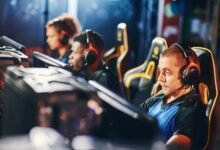 Esports team playing computer games during live gaming competition