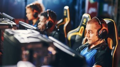 Esports team playing computer games during live gaming competition 