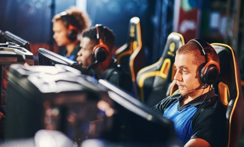 Esports team playing computer games during live gaming competition