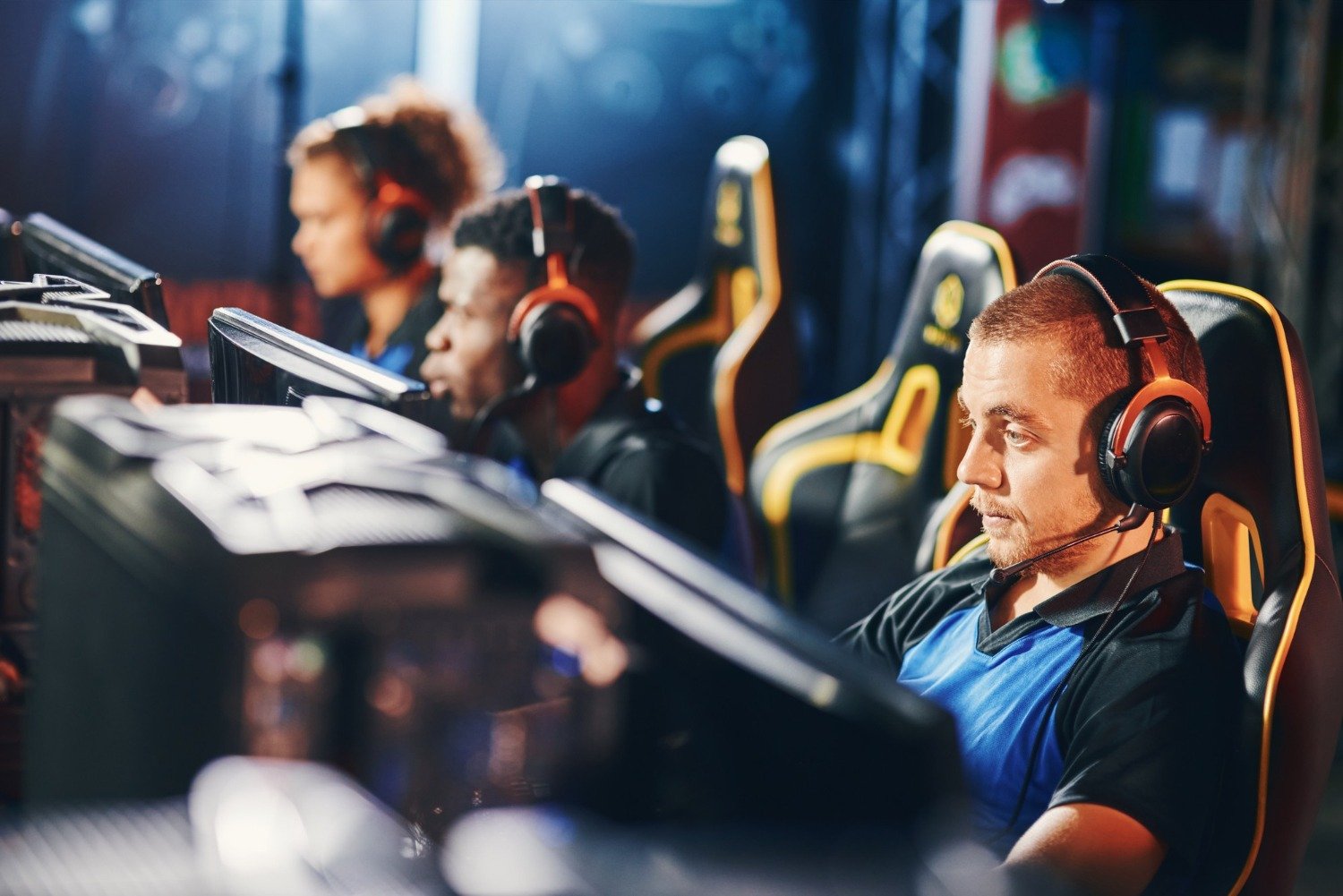 Esports team playing computer games during live gaming competition